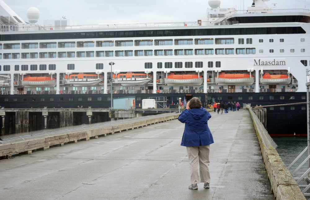 A cruise ship passenger takes a photo of the M/V Maasdam on Tuesday. The Holland America ship made its second-to-last visit to Homer on Sept. 6, bringing a burst of tourist activity to Homer after the traditional end of the tourist season on Labor Day. The Maasdam makes its last call on Sept. 20.