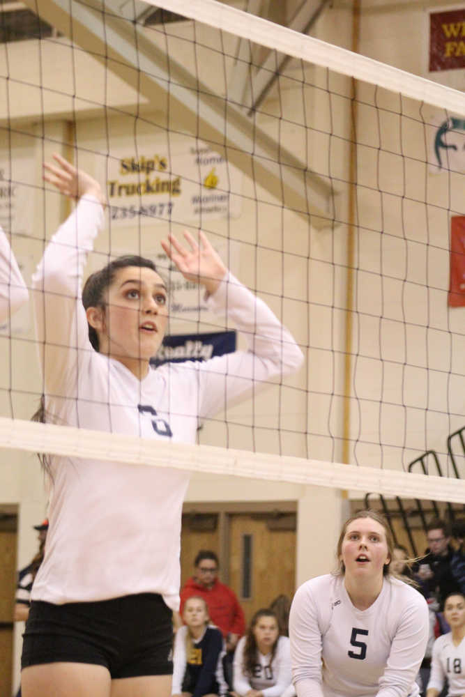 Kimberly Lynn jumps up to block while Malina Fellows readies herself to pass the ball back over the net to ACS players during the Mariners' game at home on Friday, Sept. 30.