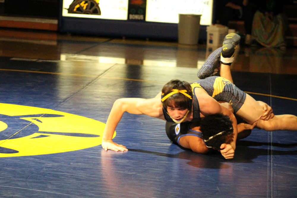 Timmy Woo works to pin down his opponent during a dual match at the Mariner wrestling team's senior night on Thursday, Nov. 10.