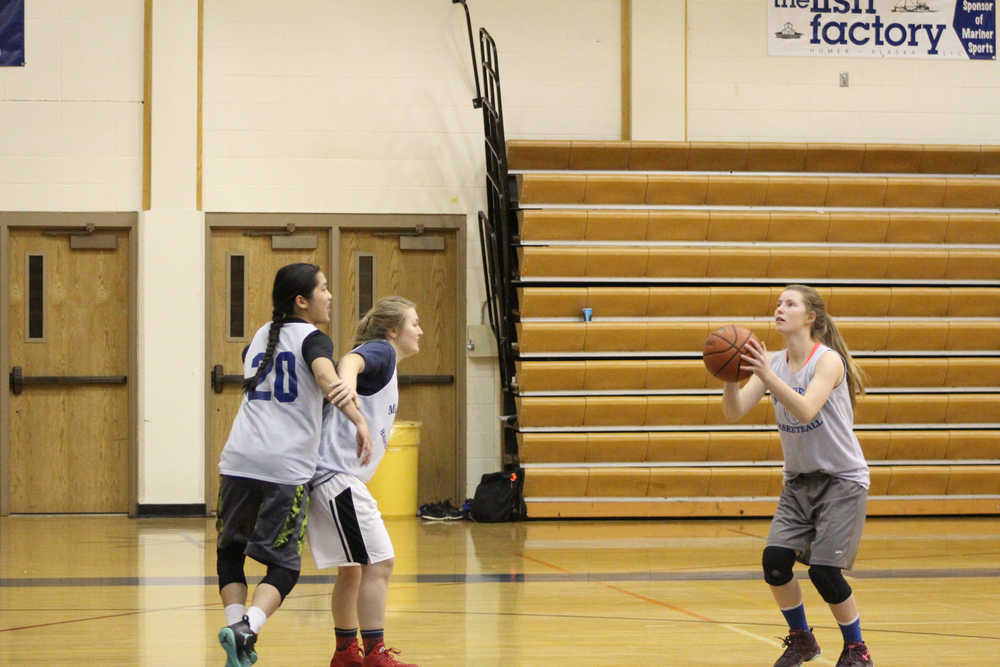 Alissa Cole shoots the ball at the hoop as Uliana Reutov blocks Kailee Veldstra during an early morning practice on Dec. 6.