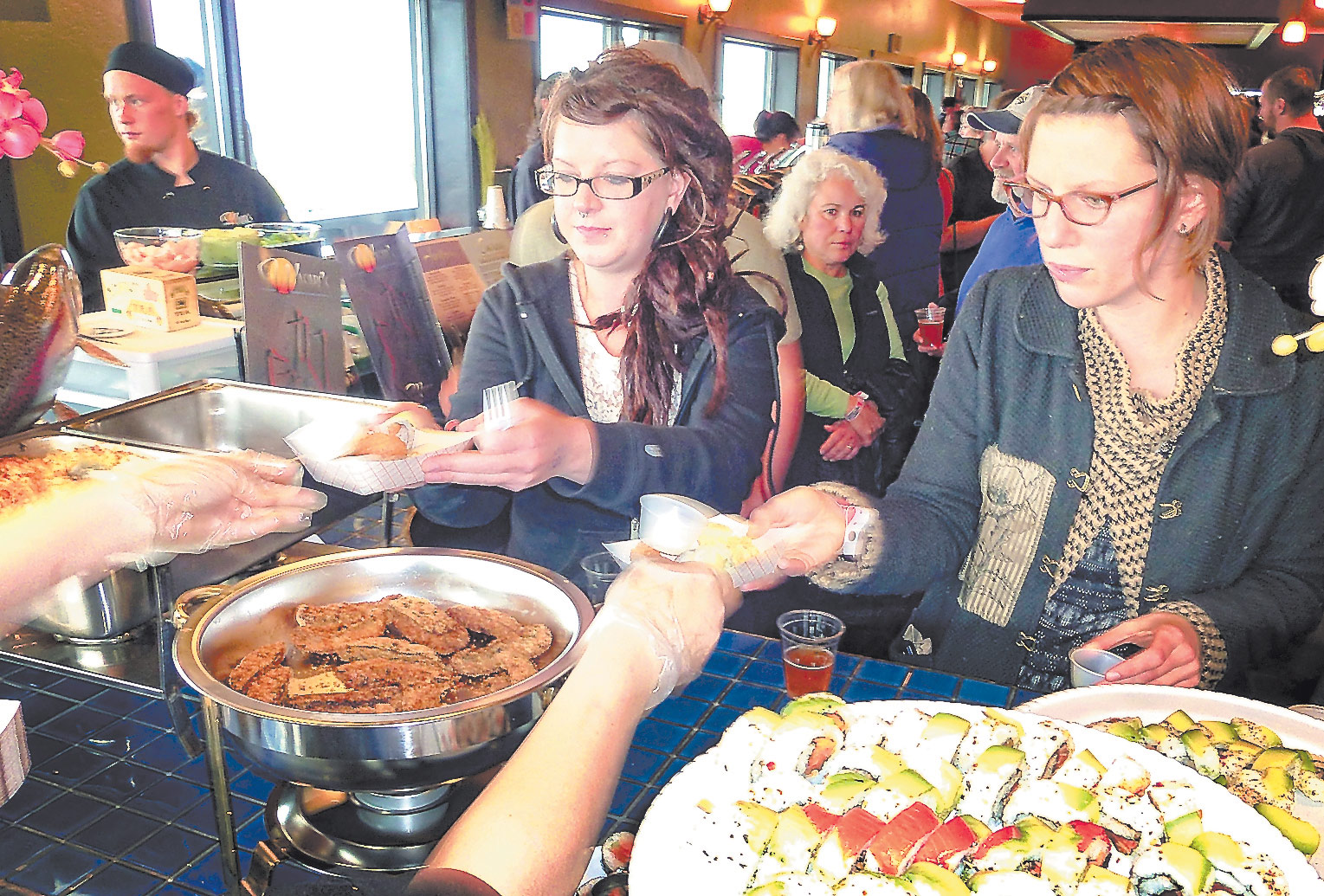 At the 2013 Taste of Homer, an eager crowd filled Wasabi’s and lined up for samples of the dishes for which Homer restaurants are known.