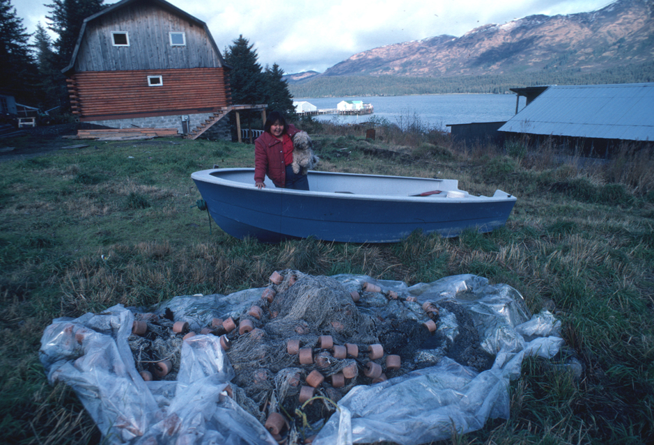 A girl plays with a dog in Port Graham in 2003. On Friday, Nov. 30, the Homer Public Library and Pratt Museum teamed up to show “Let It Grow Back,” a film about the villagers’ struggle to preserve their native language.-Photo courtesy of the Pratt Museum