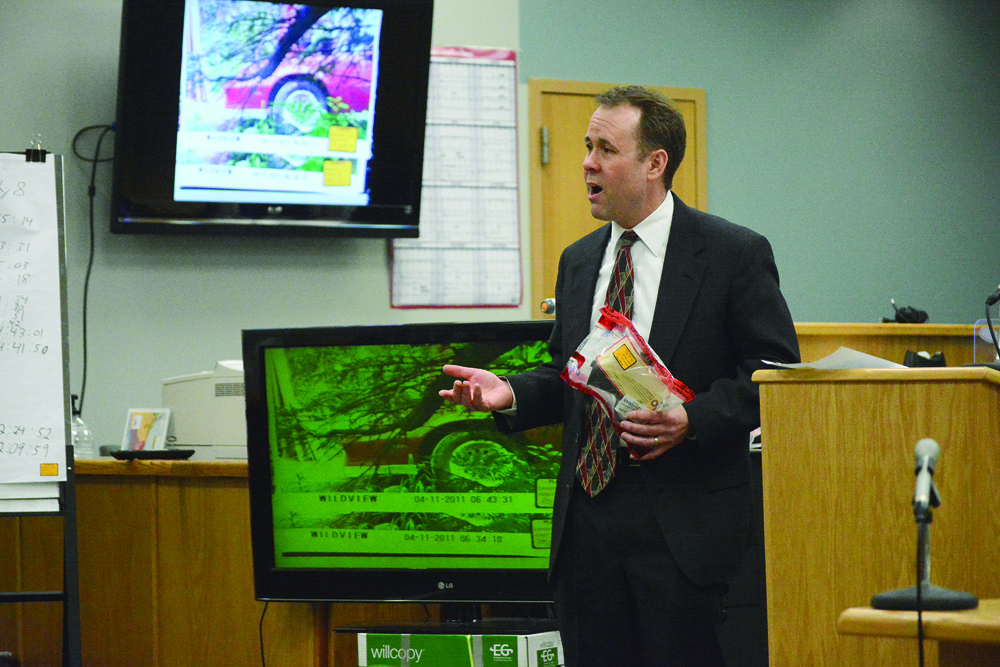 During closing arguments on Tuesday at the Homer Courthouse, Kenai District Attorney Scot Leaders holds the 9 mm Smith and Wesson pistol Demarqus Green used to kill Demian Sagerser.-Photo by Michael Armstrong, Homer News