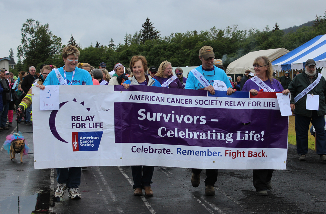 Survivors walk in 2014 and, below, 2013, at the start of Relay for Life. The annual event begins at 6 p.m. with a survivors lap around the track at Homer Middle School. Participants often wear purple, the color honoring people with cancer.-Homer News File Photo