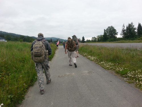 Members of the Alaskan Warrior Class Community do a 6-mile ruck march on East End Road in June.