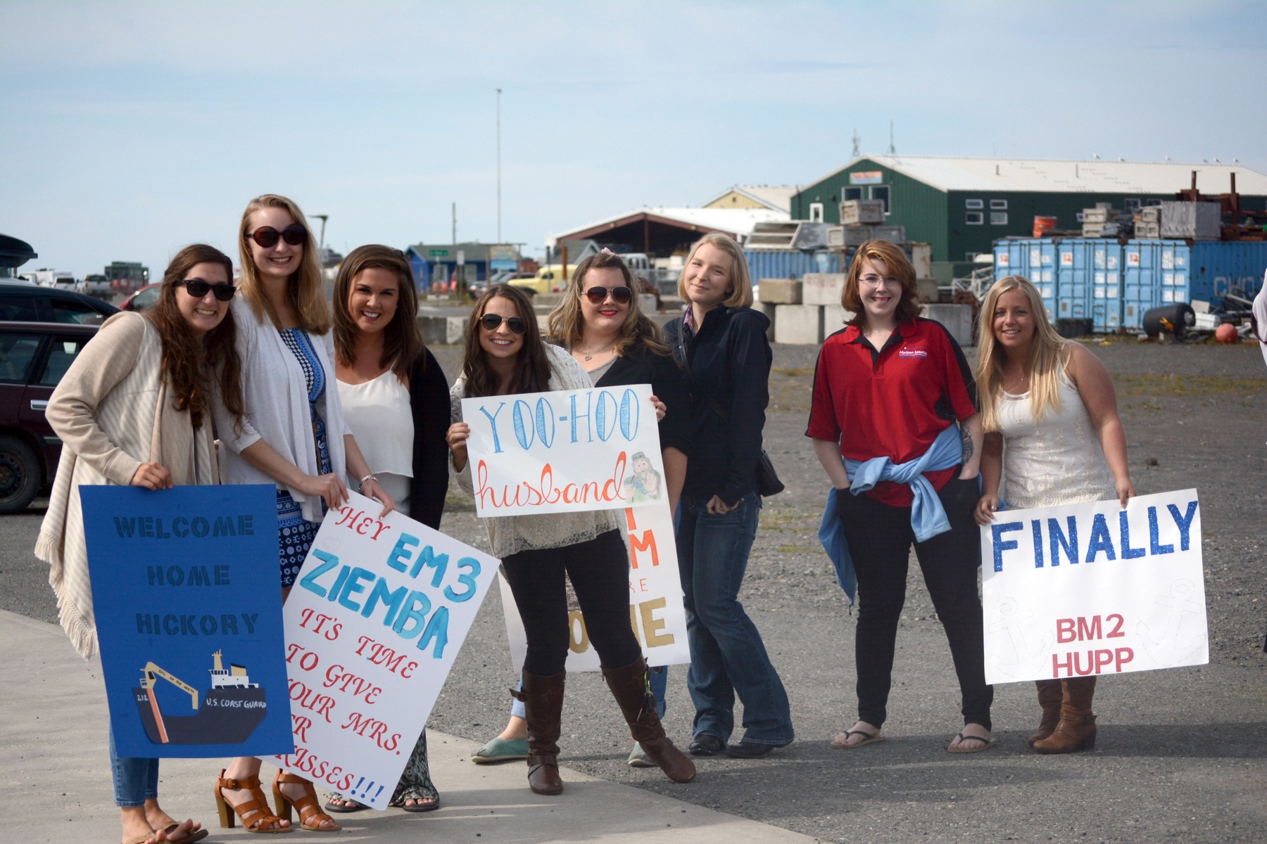 A group of U.S. Coast Guard wives wait at the Pioneer Dock in Thursday to greet their husbands after a four-month deployment on the U.S. Coast Guard Cutter Hickory. From left to right are Melissa Parker, Nicole Ziemba, Kaitlyn Burns, Emily Davis, Lyndsay McGarran, Carly Robinson, Madison Russell and Laura Hupp.-Photo by Michael Armstrong, Homer News