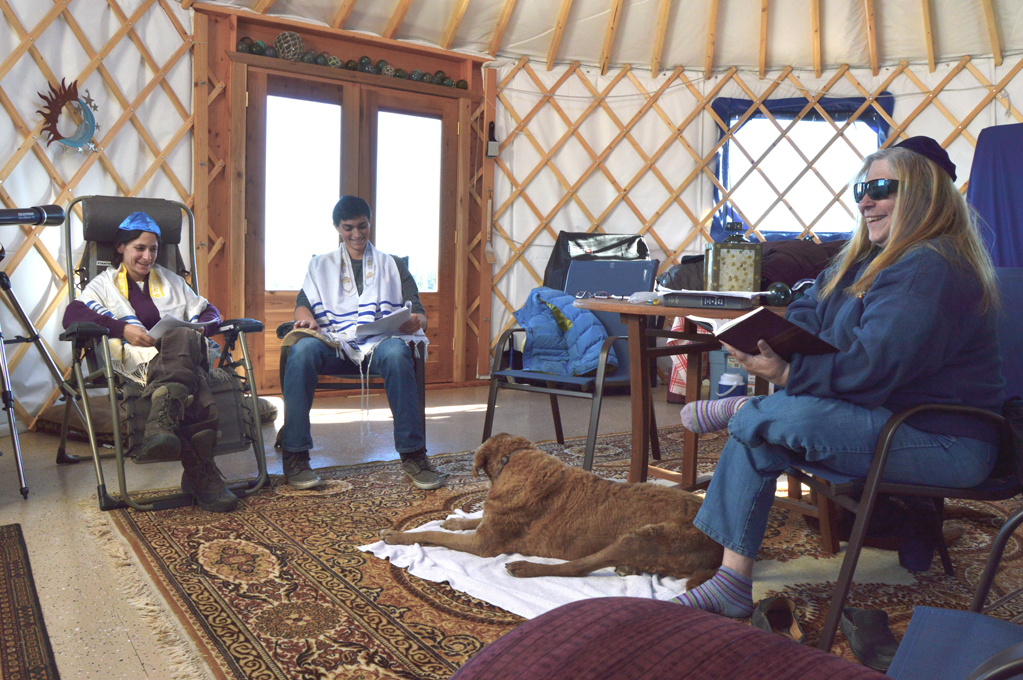 From left to right, Liz Diament, Zane Boyer, and Nona Safra read from Jewish service sheets in the Boyers’ yurt on Wednesday, Sept. 23. They’re among the Homer Jews who gathered to celebrate the High Holy Days last month.-Photo by Annie Rosenthal, Homer News