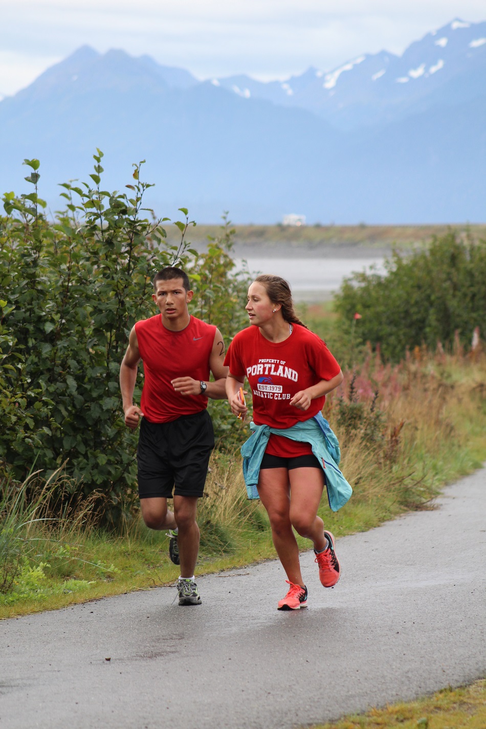 Kane Graham and Lauren Kuhns keep pace with each other as they run back down the Spit, making their way back to the high school where the finish line for the three-part race was located.  Graham finished second overall in the triathlon and Kuhns finished third overall, three seconds behind Graham.