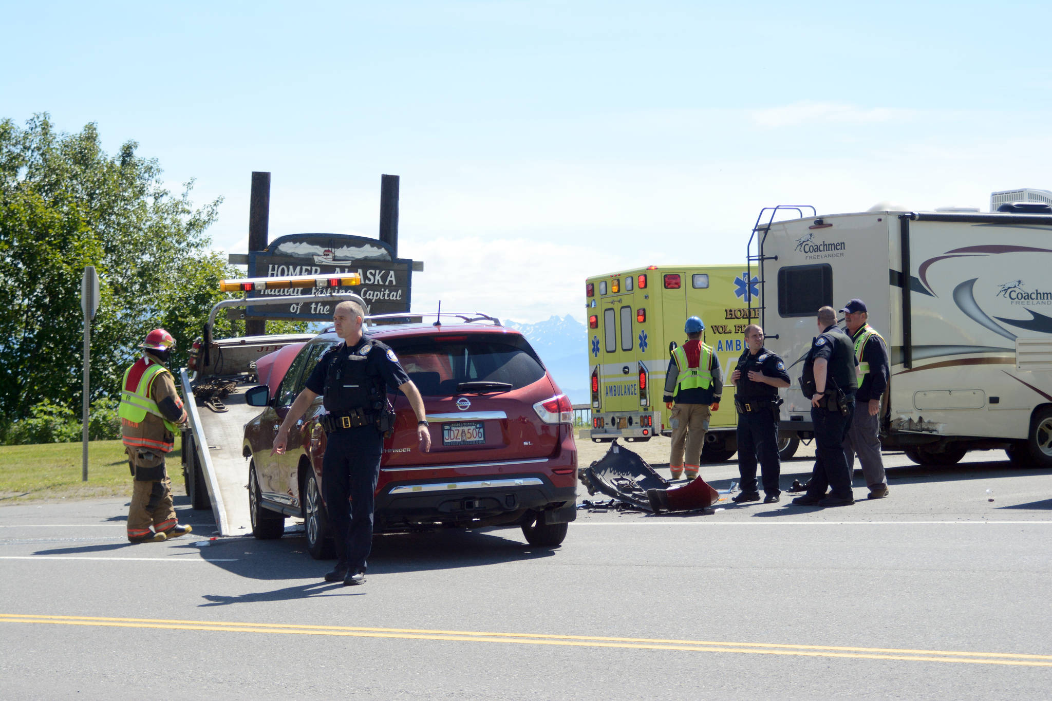 Homer Police direct traffic as a damaged Nissan SUV is loaded onto a tow truck. The Nissan struck a motorhome, right, as the motorhome turned into the Baycrest Hill viewpoint about 1 p.m. July 4. Several people were taken to South Peninsula Hospital with non-life threatening injuries.