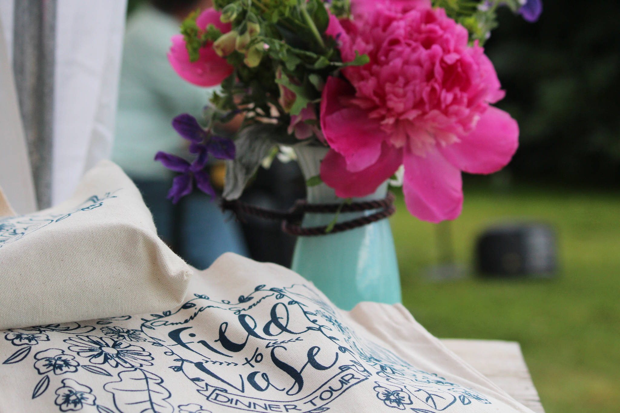 Peonies rest on a table shortly before a field to vase dinner tour hosted by Certified American Grown Flowers on Saturday, July 29, 2017 at Scenic Place Peony in Homer, Alaska. (Photo by Megan Pacer/Homer News)