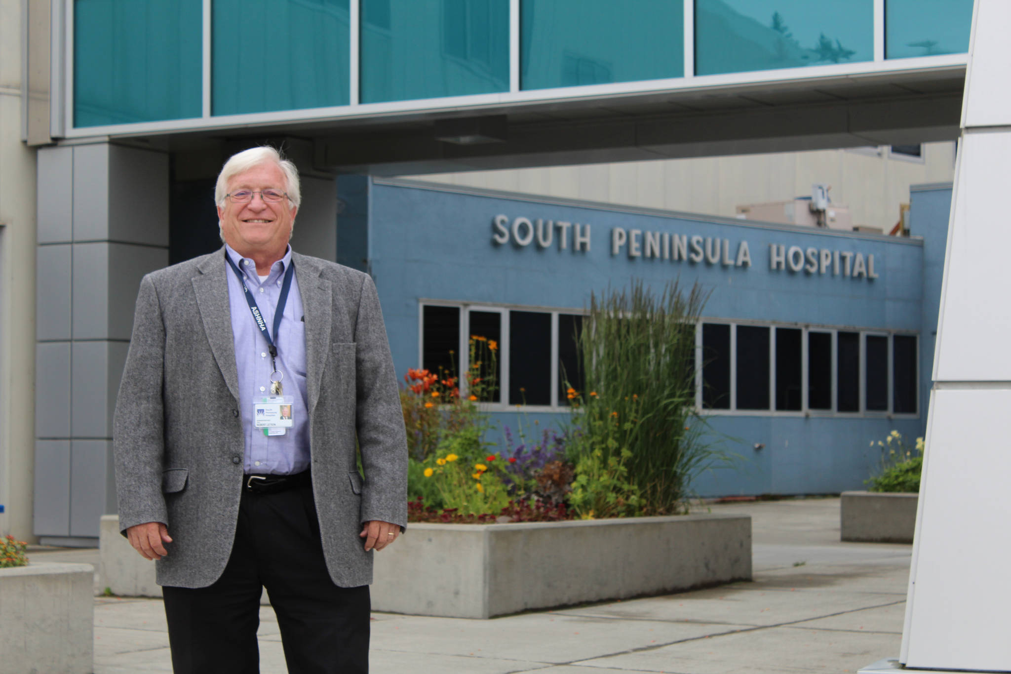 South Peninsula Hospital CEO Robert Letson poses for a photo in front of the hospital’s Bartlett Street entrance on July 9, 2016, for SPH’s 60th Anniversary Party. (Homer News file photo, Anna Frost)