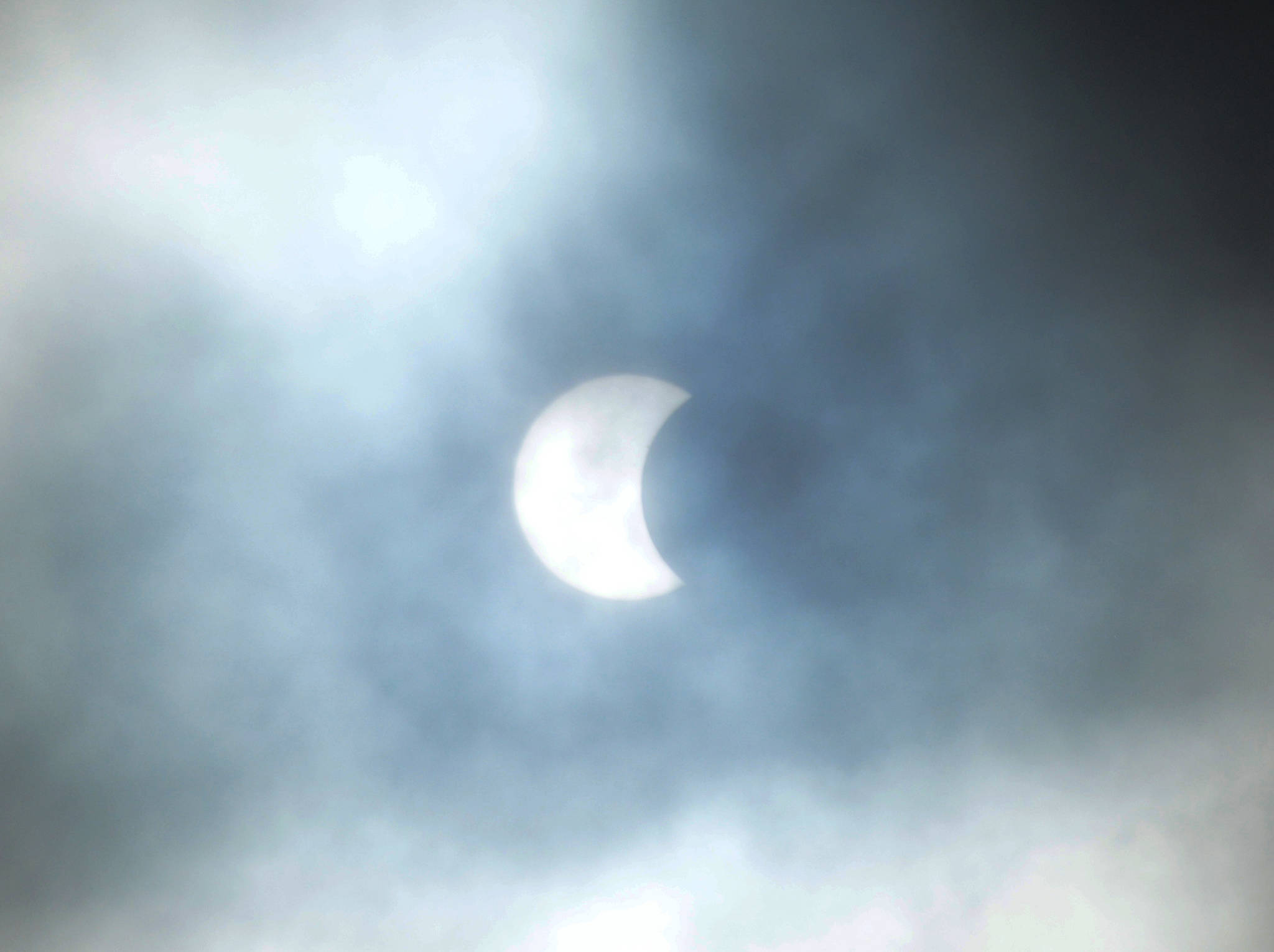 Clouds parted briefly over Homer, Alaska, at about 8:45 a.m. during a partial eclipse of the sun in this view taken from Diamond Ridge on Monday, Aug. 21, 2017. (Photo by Michael Armstrong, Homer News)