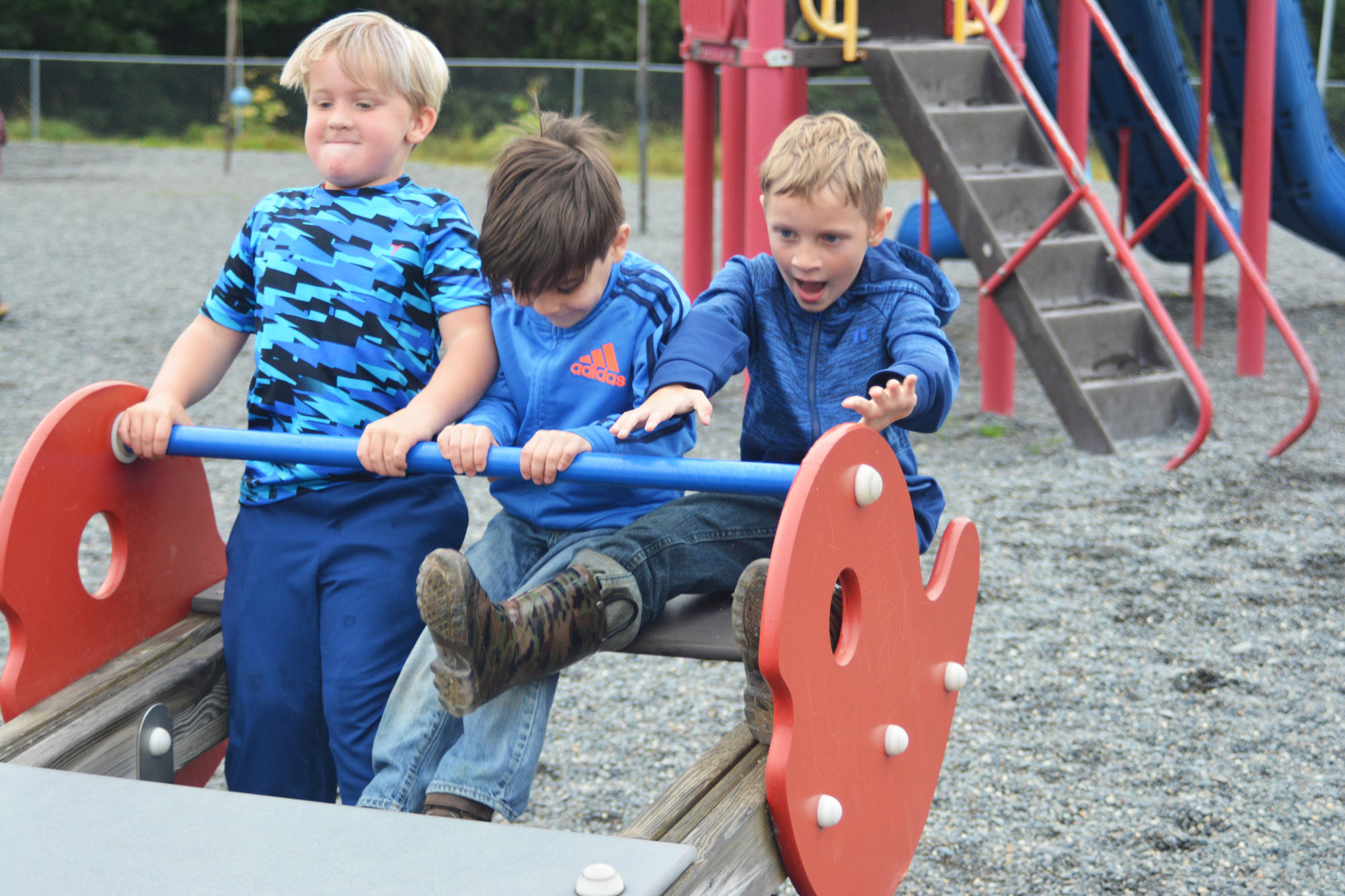 From left to right, Sullivan Shelby, Thomas Wetherill and Grayson Hansen enjoy their recess time during the first day of school Tuesday, Aug. 22, 2017 at Paul Banks Elementary in Homer, Alaska. (Photo by Megan Pacer/Homer News)