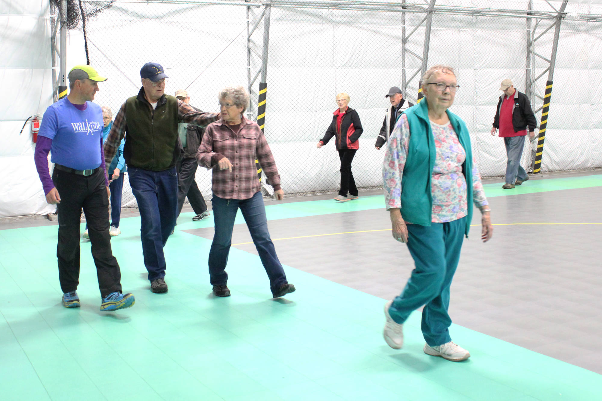 Dr. Rob Downey, functional medicine provider and chief of staff at South Peninsula Hospital (far left) talks with community members during the first ever Walk with a Doc event Saturday, Oct. 7, 2017 at the newly completed South Peninsula Athletic and Recreation Center in Homer, Alaska. The walks are part of a national program and will take place monthly with rotating doctors to help people get exercise and health advice at the same time. (Photo by Megan Pacer/Homer News)