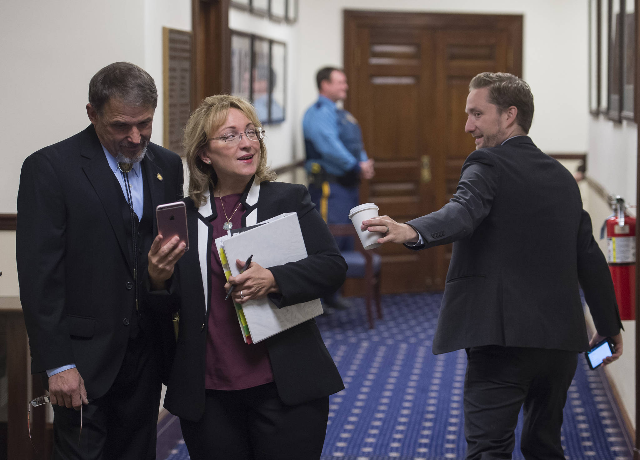 Rep. George Rauscher, R-Palmer, left, Colleen Sullivan-Leonard, R-Wasilla, center, and Rep. Jason Grenn, NA-Anchorage, greet each other on the first day of the fourth Special Session of the 30th Alaska Legisture on Monday, Oct. 23, 2017. (Michael Penn