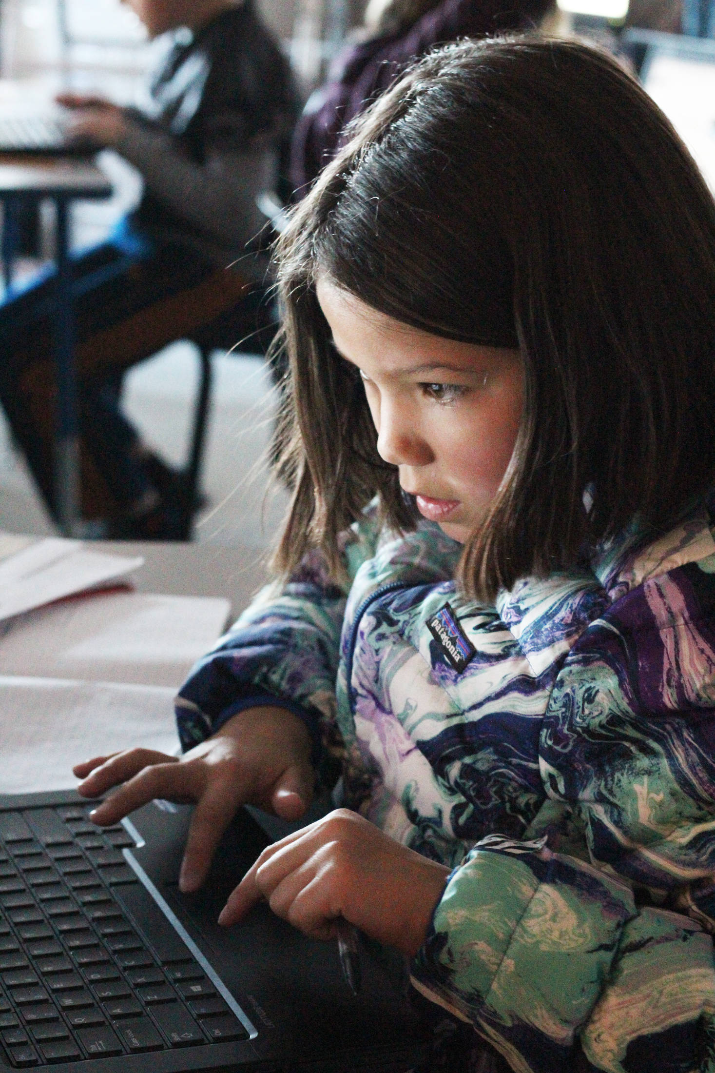 Fifth grader McKenna Carlin uses her classroom computer to do some research during a special lesson taught retired McNeil Canyon teacher Bill Noomah on Thursday, Oct. 19, 2017 at West Homer Elementary School in Homer, Alaska. The lesson, created from a collection in the Veterans History Project at the Library of Congress, is meant to teach students about Veterans Days as well as how to use primary sources in investigations. (Photo by Megan Pacer/Homer News)