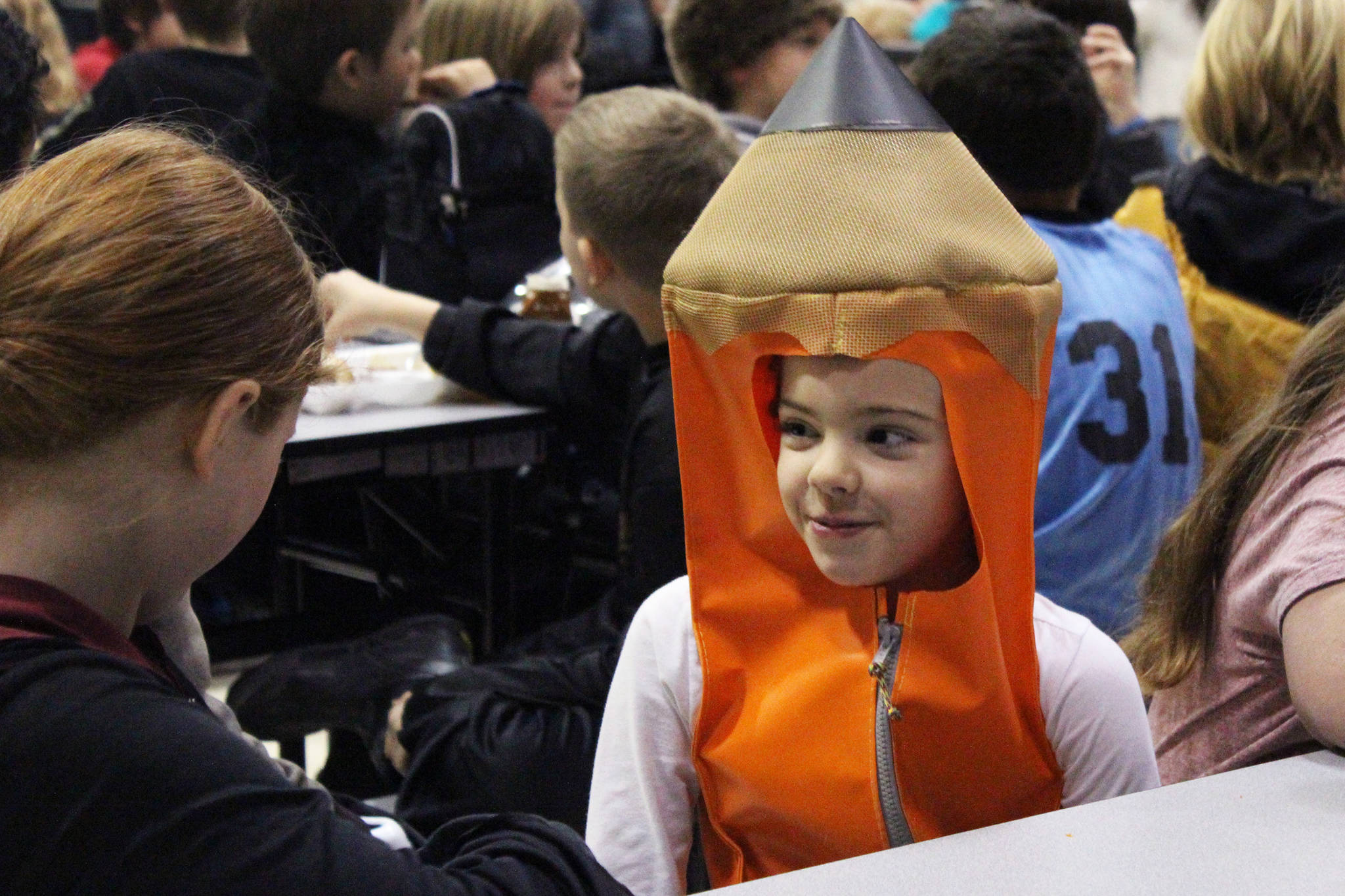 Fireweed student Madelyn Madrid chats in her pencil costume during lunch Tuesday, Oct. 31, 2017 at West Homer Elementary School in Homer, Alaska. Several area schools held costume parades and other celebrations for Halloween. (Photo by Megan Pacer/Homer News)