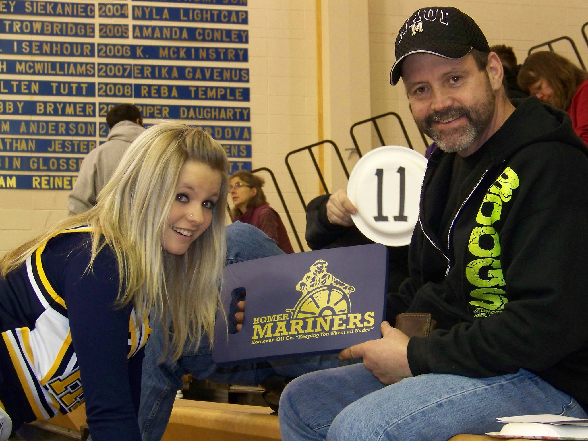 Breeanna Torsen, left, poses for a photo with her dad, Brant “Boog” Torsen, in a December 2013 file photo for a Meet the Mariners fundraiser. (Homer News file photo)