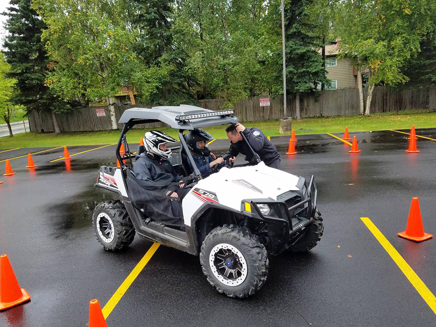 Homer PD’s Sgt. Ryan Browning (right) talks to a teen driver while he traverses a course with Officer Jim Knott (left) at a Project Drive clinic they put on in Anchorage. The department has put hundreds of students through the anti-drunk driving educational clinic since it began in 2011. (Photo courtesy Ryan Browning)