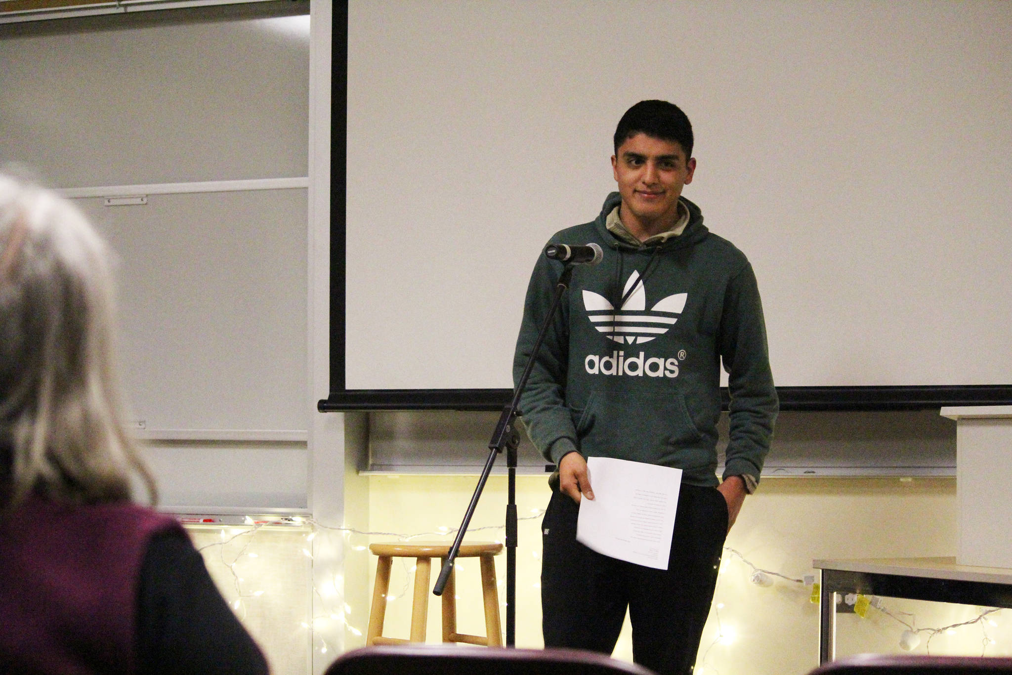 Pedro Ochoa, the assistant cross-country team coach, reads a sonnet he wrote during a Coffee House event held Tuesday, Dec. 5, 2017 at Pioneer Hall on Kachemak Bay Campus in Homer, Alaska. The event was put on by the school’s Student Association and was an opportunity for student, many of whom were taking a creative writing class, to share their work aloud in public. (Photo by Megan Pacer/Homer News)