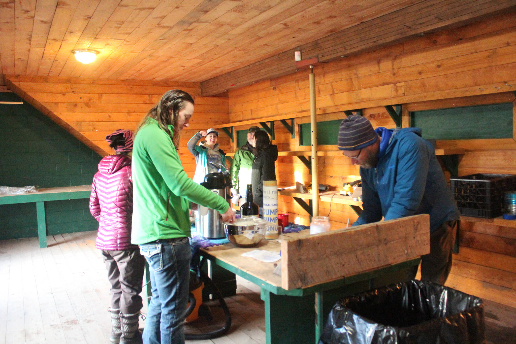 Members of the Homer cycling community partake of snacks during a open house Sunday, Dec. 17, 2017 for Cycle Logical at its new location on Pioneer Avenue in Homer, Alaska. The shop will move from its East End Road location. (Photo by Megan Pacer/Homer News)