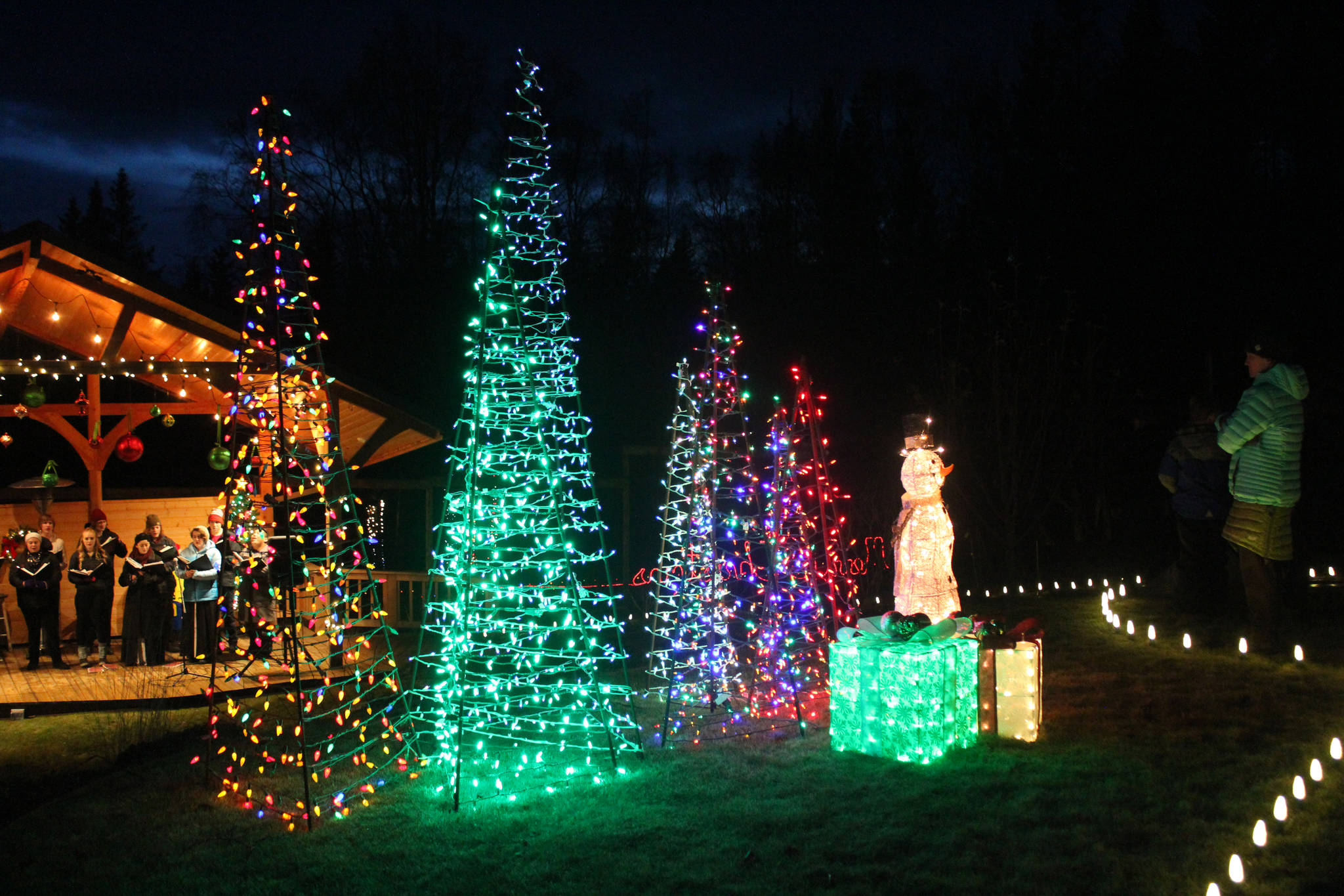 Lighted tree and present structures decorate the lawn Saturday, Dec. 16, 2017 at the Bear Creek Winery Gardens near Homer, Alaska which host a lighted walk each year complete with performances of the Homer High School Swing Choir. (Photo by Megan Pacer/Homer News)