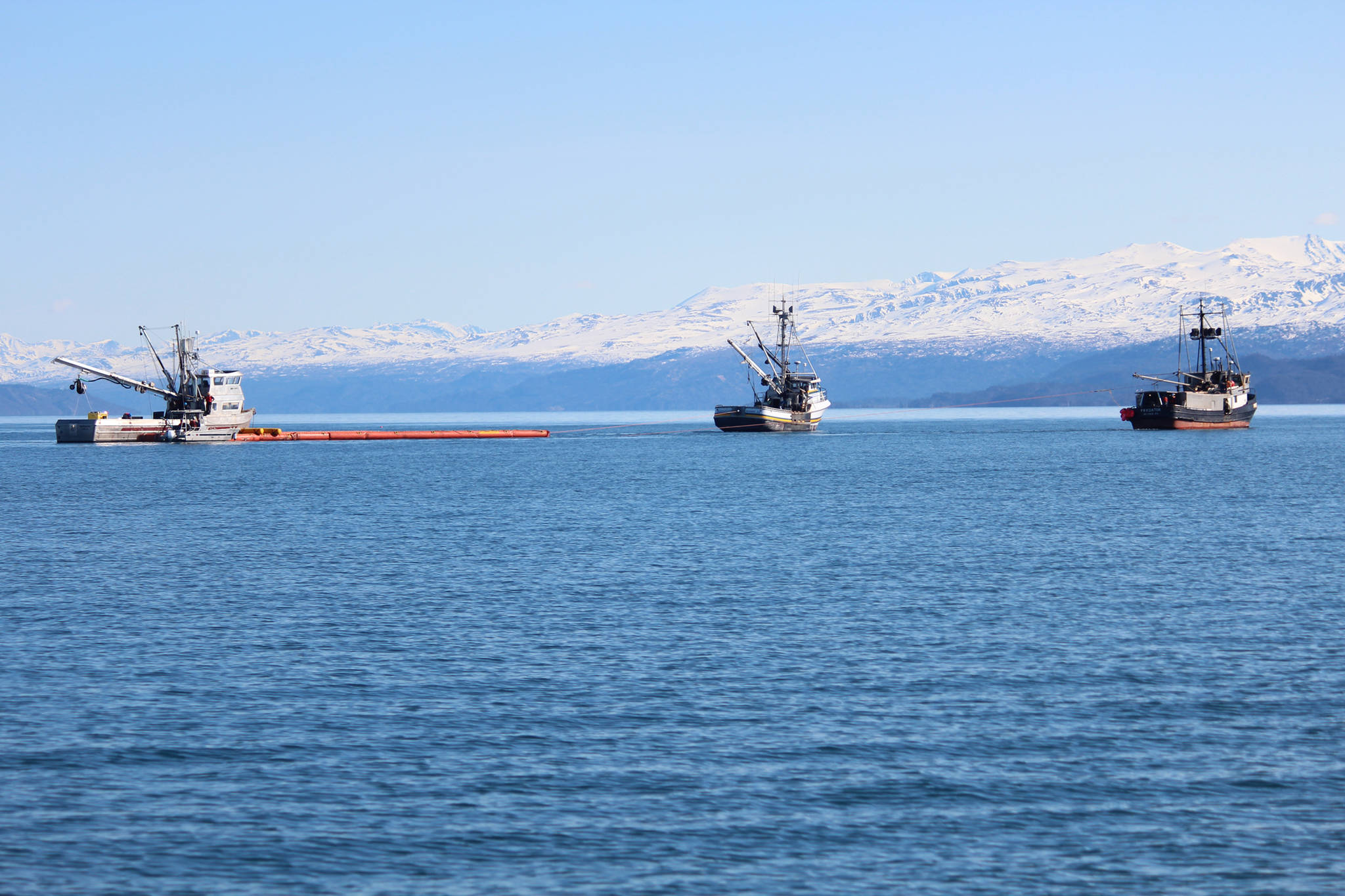 Photo by Megan Pacer/Homer News Three fishing vessels navigate a boom around Kachemak Bay during annual oil spill response training Saturday, April 14 in Homer. Training organizers set out red buoys to simulate areas on oil slick the boats needed to aim for.