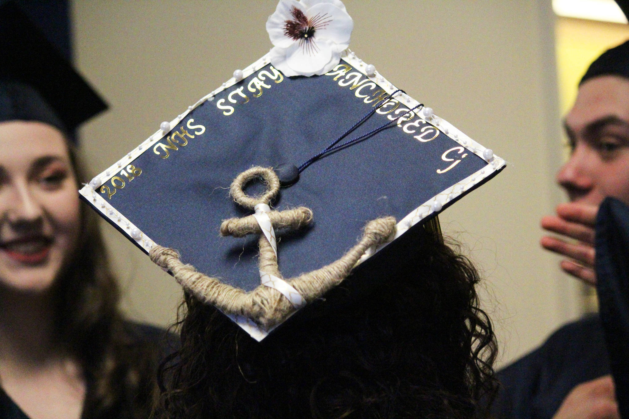 Photo by Megan Pacer/Homer News Ninilchik School graduate Chelsea Oberle-Lozano waits with her classmates to walk into their graduation ceremony Monday, May 21, 2018 at the school in Ninilchik, Alaska. Her graduation cap reads: “Stay anchored.”