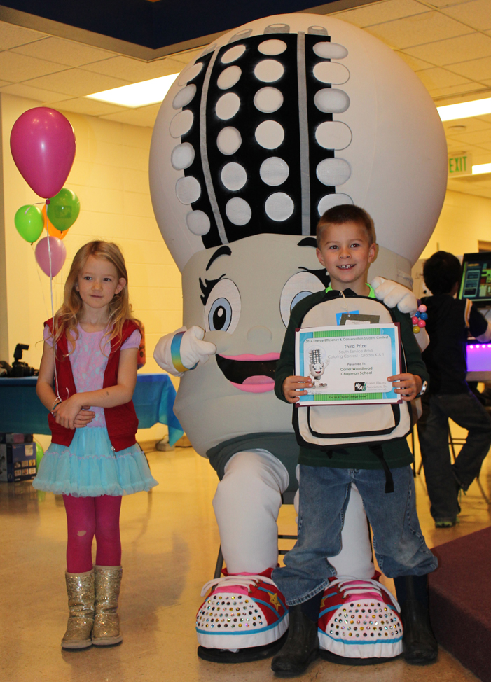 Kallan Johnson, left, of McNeil Canyon Elementary School and Carter Woodhead of Chapman School pose with Homer Electric Association’s LED Lucy after winning first place and third place, respectively for grades K-1 in HEA’s south service area energy conservation contest. -Photo by McKibben Jackinsky, Homer News