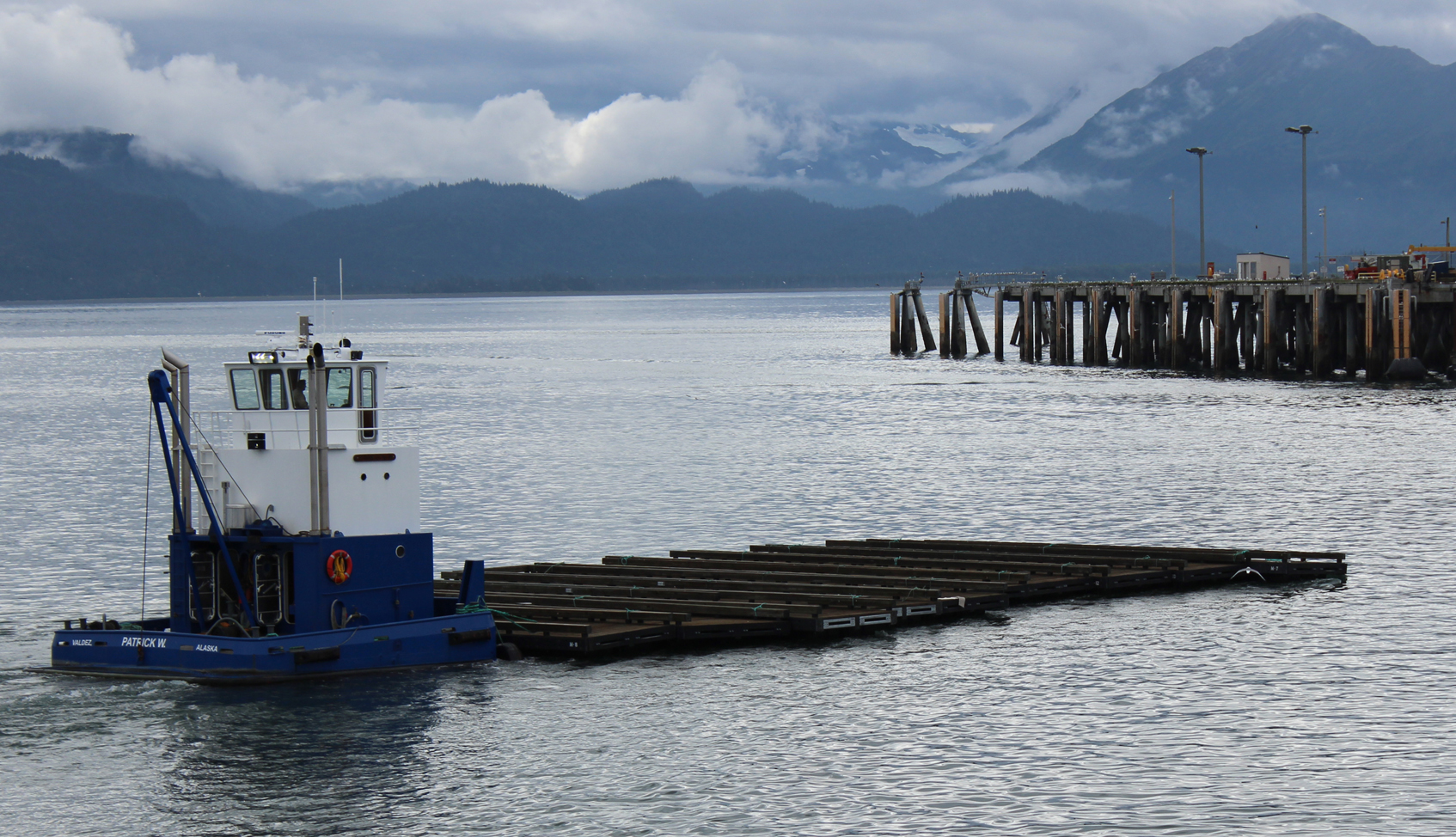 Tuesday afternoon a push boat owned by Harris Sand and Gravel of Valdez moves new floats into the Homer harbor for installation in September.-Photo by McKibben Jackinsky, Homer News