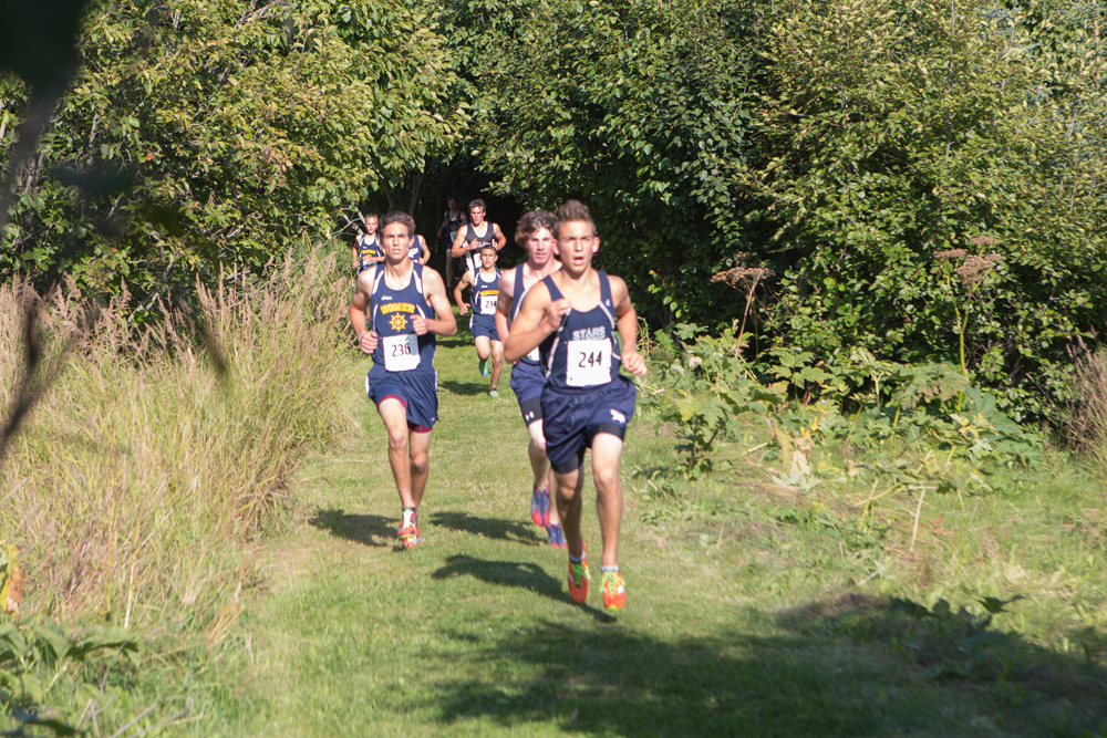 Mariner Charlie Menke leads a pack of runners on the trail during last Friday’s Homer XC Invite.