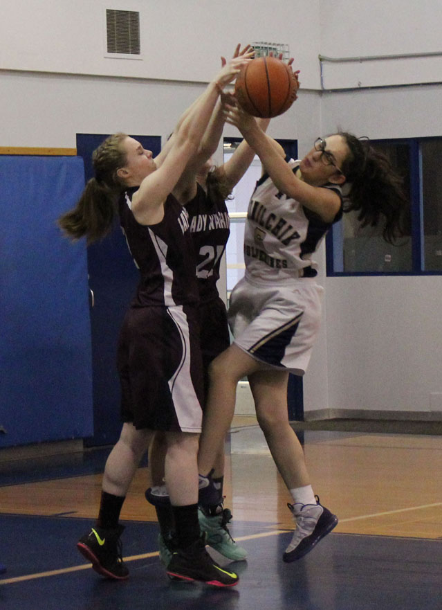 Ninilchik’s Olive Delgado, right, fights for control of the ball with Nikolaevsk’s Kilina Klaich, left, and Serafima Kalugin, center.-Photo by McKibben Jackinsky, Homer News