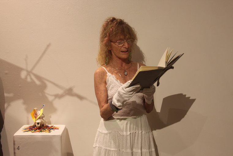 Jo Going reads a poem during the opening reception of her art exhibit, Reliquary, on June 27 at the Pratt Museum. Reliquary is on exhibit through Sept. 21.-Photo by Shannon Reid