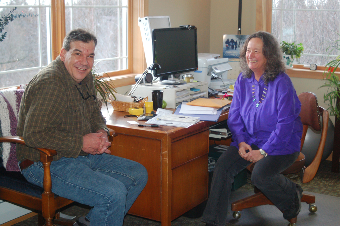 Disability rights specialist Rick Malley, left, visits with Independent Living Center director Joyanna Geisler, right, in her office. The ILC recently moved into new offices on Pioneer Avenue and held an open house last Friday.-Photo by Michael Armstrong, Homer News