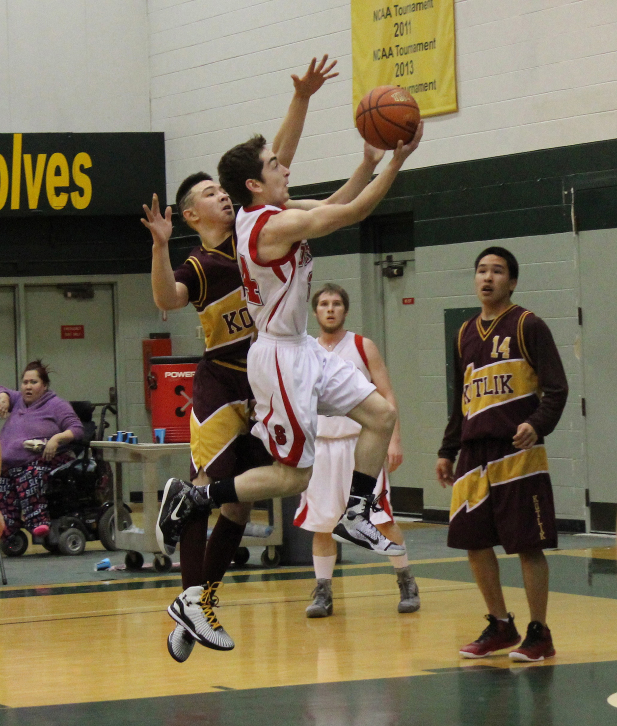 Seldovia’s Calem Collier flies through the air to control the ball in the Seldovia Otters’ game against the Kotlik Falcons during state 1A tourney action in March of this year.-Photo by McKibben Jackinsky, Homer News