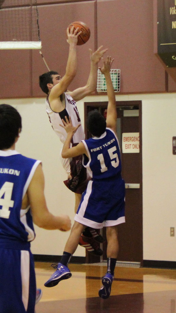 Nikolaevsk’s Greg Trail, center, shoots for two during the Friday night game between the Nikolaevsk Warriors and the Fort Yukon Eagles. -Photo by McKibben Jackinsky, Homer News