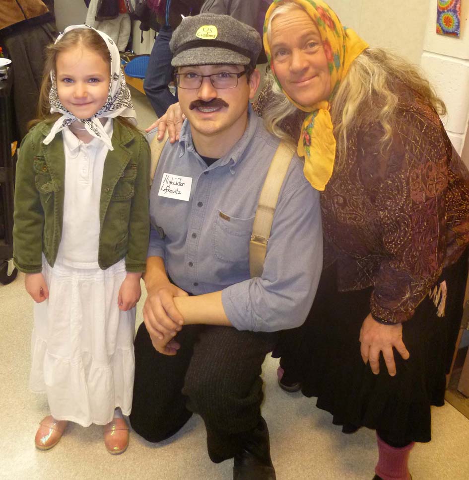 Student Tiya Martushev plays the role of a seamstress and nurse from the Netherlands; teacher David Lefton plays the part of Highwater Lefkowitz from Austria; and teacher Kim Fine plays the part of Rosina Nazzao, a ravioli maker from Italy, during a recent Fireweed Academy activity about Ellis Island.-Photo provided