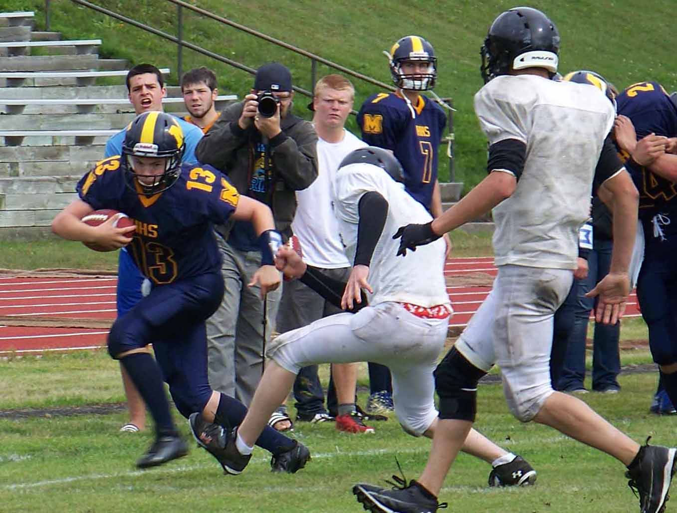 Mariner Ian Lowe maintains possession of the football during Homer High School’s scrimmage on Saturday with the Voznesenka Cougars.-Photo by McKibben Jackinsky, Homer News