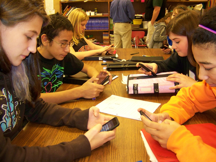 Chapman School seventh- and eight-graders Diana Gaedecke, Billy Johnson, Laila Isaac, Katrina Applehanz (not seen), Heather Harrington and Uno Mireles use iPods to define and find examples of convection, conduction and radiation.-Photos by McKibben Jackinsky, Homer News