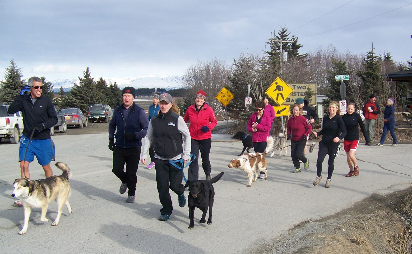 Walkers, runners and a few canine companions set off on a Friday Night Five, a 5K noncompetitive event sponsored by the Kachemak Bay Running Club and organized by club member Rachel Lord, center. -Photo by McKibben Jackinsky, Homer News