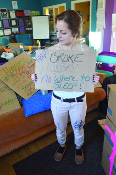 Casey Marsh holds up a sign for her senior project, the Triple H’s of Homer. Marsh has planned a sleep-out in WKFL Park on Nov. 7 to raise awareness about youth homelessness on the peninsula.-photo by Annie Rosenthal, Homer News