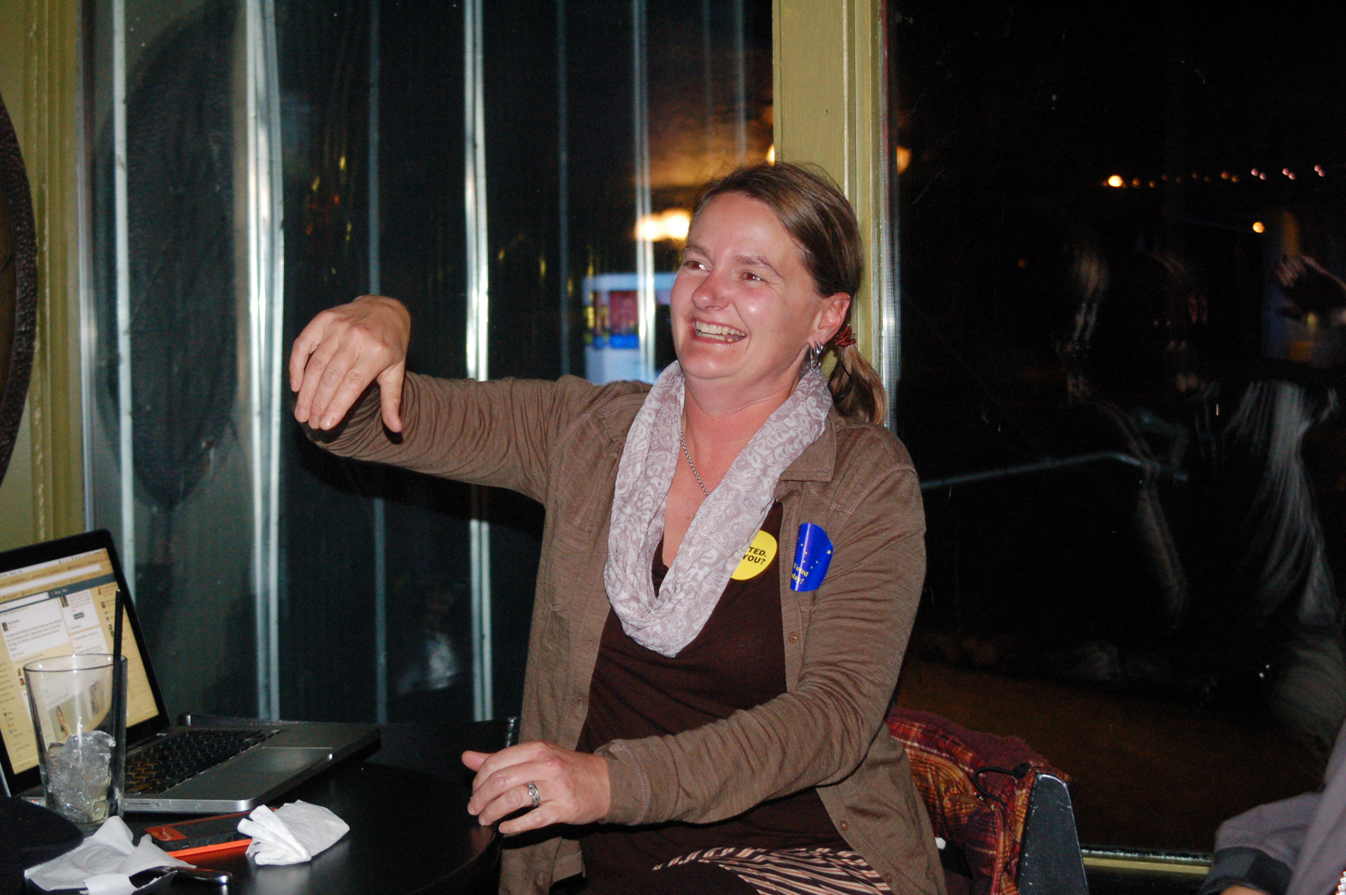 Homer City Council candidate Catriona Lowe smiles after hearing that she won election. Lowe held an informal election party at The Alibi. Mayor Beth Wythe, who was re-elected to a second term, stopped by to congratulate Lowe.-Photo by Michael Armstrong, Homer News