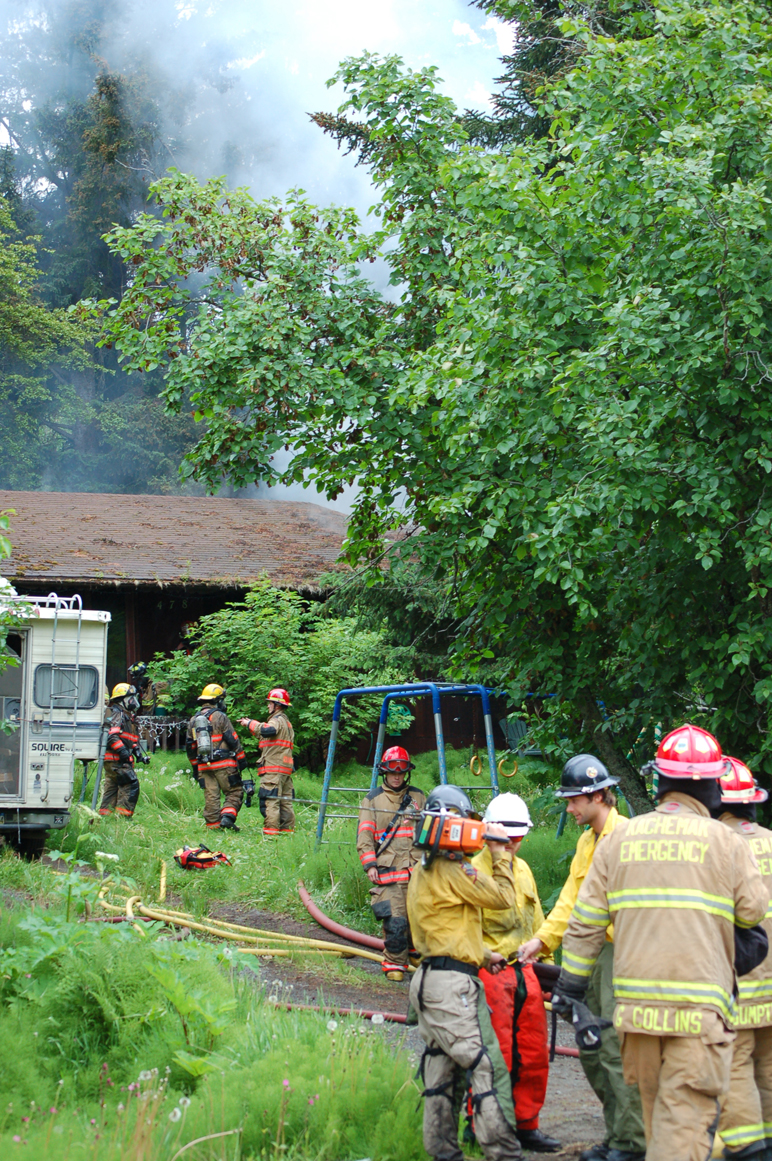 Homer Volunteer Fire Department, Kachemak Emergency Services and Alaska Division of Forestry firefighters respond to the Rainbow Court fire last Friday. A person died in the fire.-Photo by Michael Armstrong, Homer News