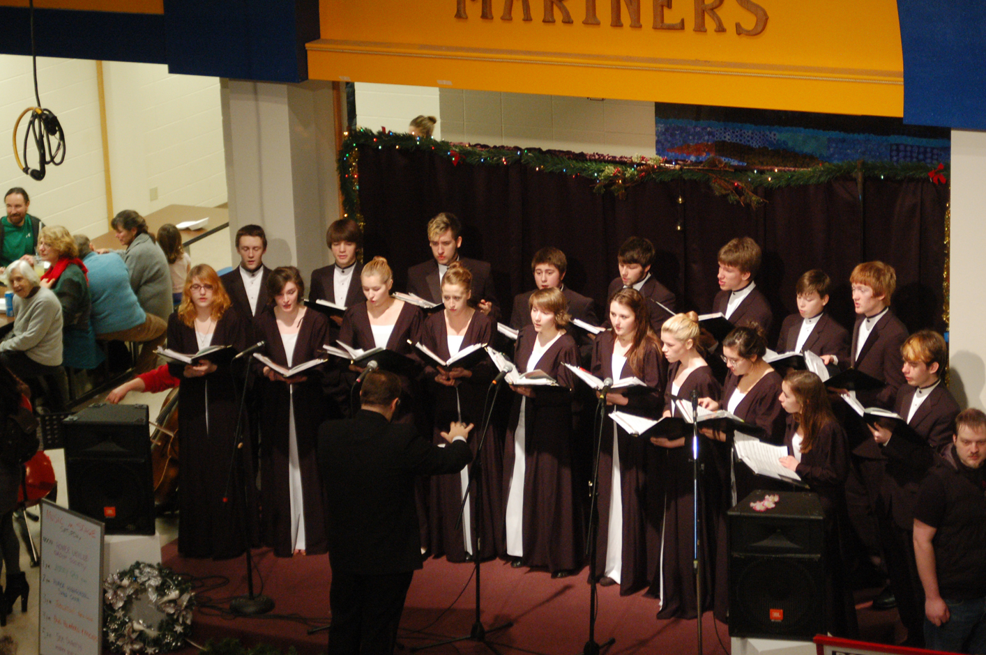 Kyle Schneider directs the Homer High School Concert Choir as it sings Irving Berlin’s “White Christmas” last Saturday at the Nutcracker Faire. A flash mob chorus and Jubilation, the Homer United Methodist Church bell choir, joined the choir.-Photo by Michael Armstrong, Homer News