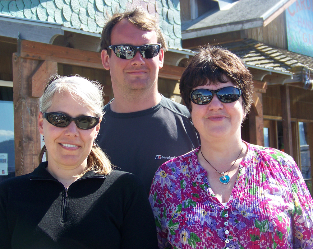 Simyra Taback, left, of Hallo Bay Bear Camp, shares some Spit sunshine July 11 with Wanderlust photographer Simon Chubb and the travel magazine’s co-founder and editor in chief Lyn Hughes.-Photo by McKibben Jackinsky, Homer News