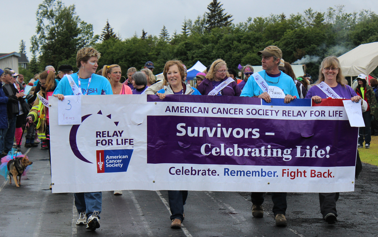 Tammy Ackerman, Ginger VanWagoner, Rick and Tanya Norvell lead the cancer-survivor lap of Homer Middle Schoool track on Friday, officially launching the 2014 Relay for Life of Homer.-Photo by McKibben Jackinsky, Homer News