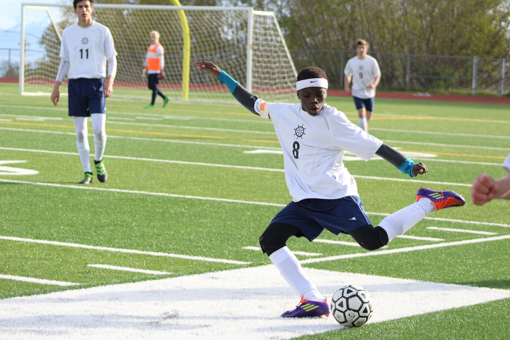 Nouredine Mama winds up to kick the ball across the field, away from Colony players, during the May 6 home game. -Photo by Anna Frost; Homer News