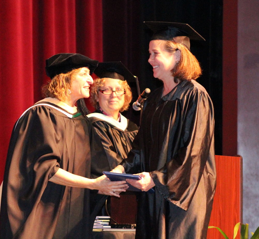 Jill Burnham receives her degree from Kachemak Bay Campus Director Carol Swartz at KBC’s May 4 graduation. Burnham moved to Homer in October 2015 and completed her associates degree, which she started in 1981 before pursuing a career in the arts.-Photo by Anna Frost, Homer News