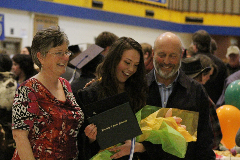 Valedictorian Shannon Reid laughs as she takes photos with her parents Linda and Ian Reid at the reception after the Kachemak Bay Campus of Kenai Peninsula College graduation ceremony on May 4.-Photo by Anna Frost, Homer News