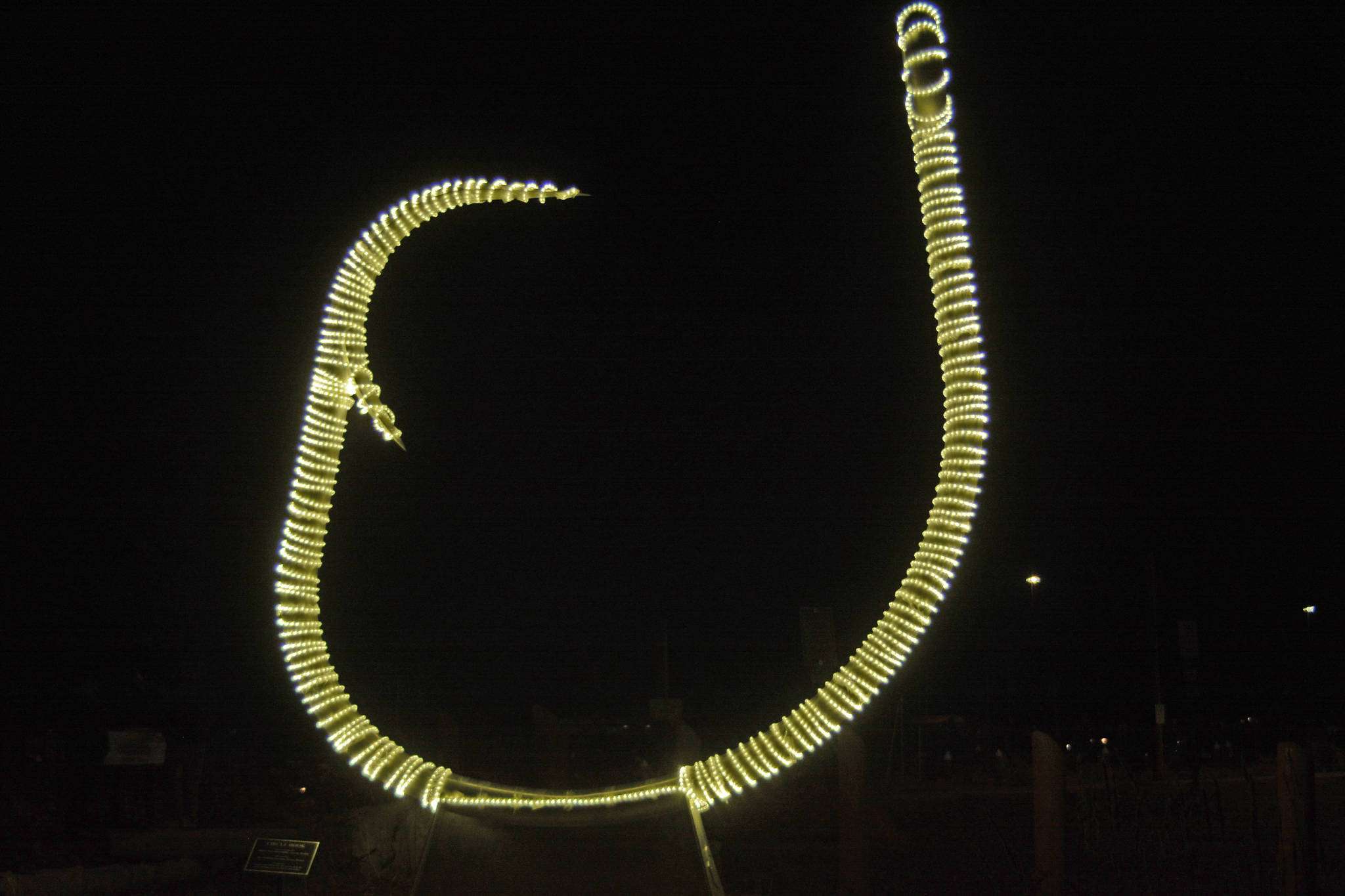 The halibut hook at the Homer Harbor has been wrapped in lights for the dark winter on Nov. 17, 2018, in Homer, Alaska. (Photo by Michael Armstrong/Homer News)